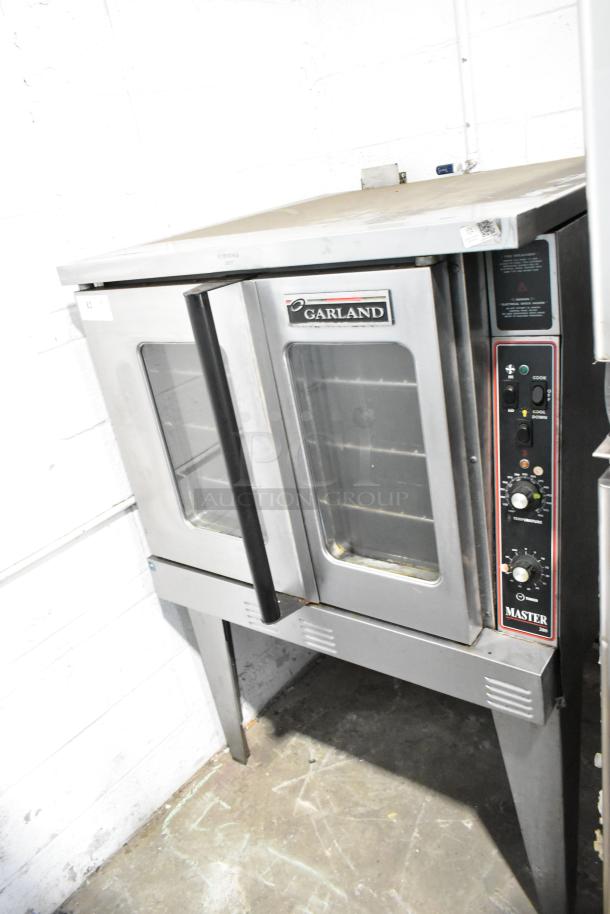 Garland Master 200 stainless steel commercial convection oven with view-through doors, metal racks, and thermostatic controls.