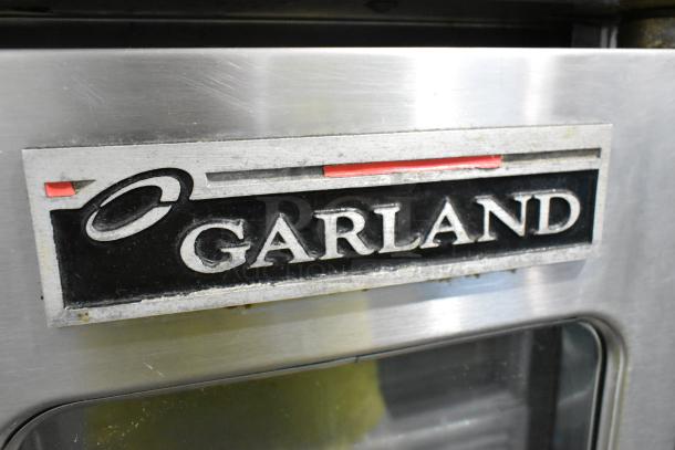 Garland Master 200 stainless steel commercial convection oven with view-through doors, metal racks, and thermostatic controls.