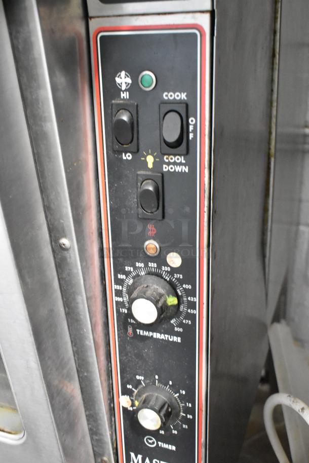 Garland Master 200 stainless steel convection oven controls, featuring temperature and timer dials, with visible wear.