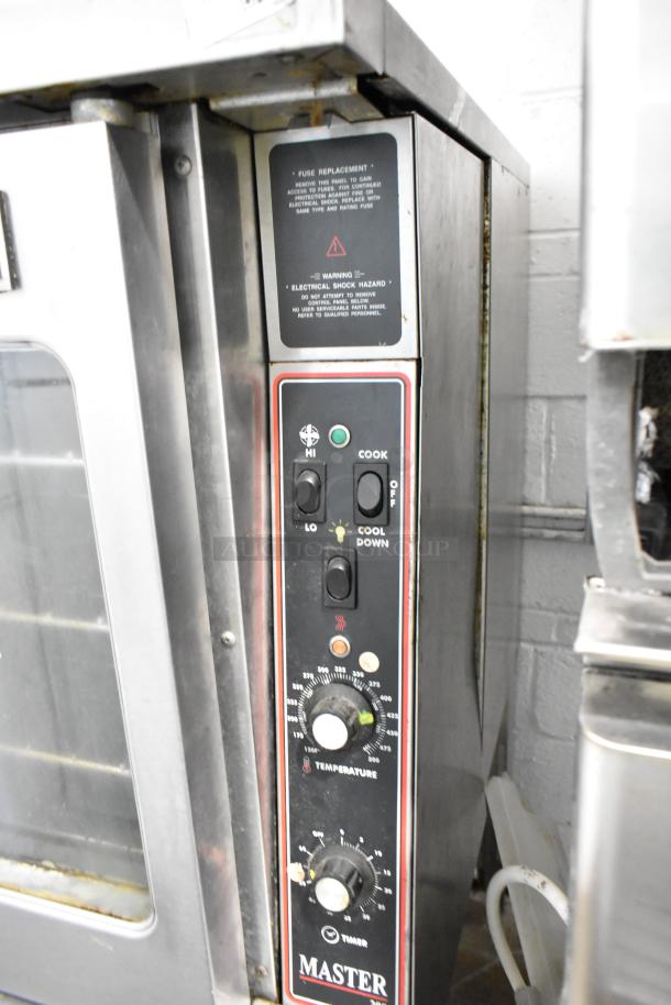 Garland Master 200 stainless steel commercial convection oven with view-through doors, metal racks, and thermostatic controls.