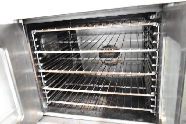 Garland Master 200 stainless steel commercial convection oven with view-through doors, metal racks, thermostatic controls, on metal legs.