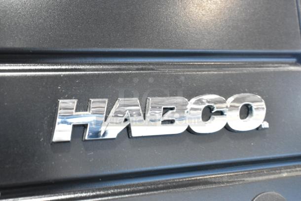 Close-up of Habco logo emblem on the SE18 metal cooler merchandiser, 2019 model, showing durable construction details.