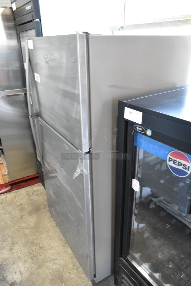 2025 Whirlpool WRT311FZDM05 stainless steel refrigerator with freezer. 115 volts, 1 phase. Minor surface scratches visible.