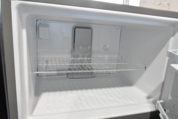 2025 Whirlpool WRT311FZDM05 stainless steel refrigerator with freezer, 115 volts, 1 phase, interior view, empty shelves.