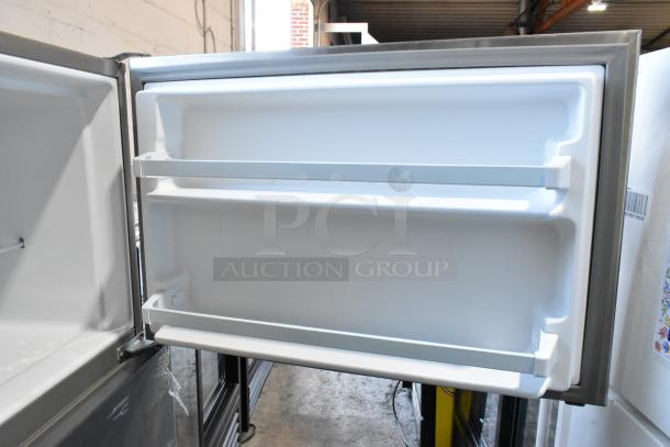 2025 Whirlpool WRT311FZDM05 stainless steel cooler with freezer, open door showing interior shelves, 115 volts, 1 phase.