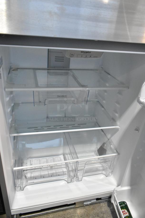 2025 Whirlpool WRT311FZDM05 stainless steel cooler with freezer, open view showing adjustable shelves and bins. Model tag inside.