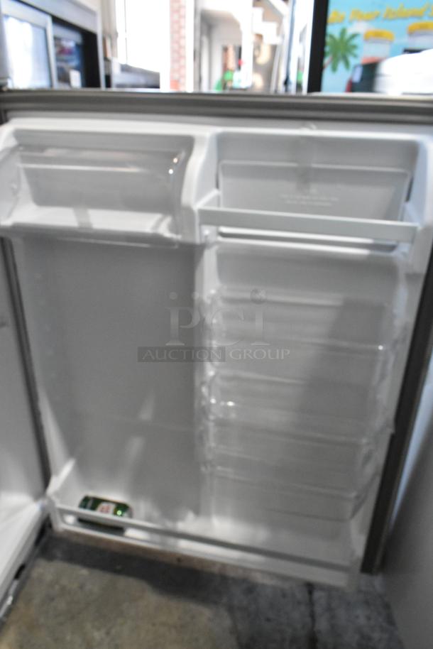 2025 Whirlpool WRT311FZDM05 stainless steel cooler with freezer, open door view, pristine interior, shelves visible.