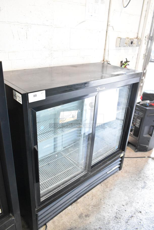 True Metal Commercial 2-Door Cooler Merchandiser, features poly-coated racks, 115 volts, 1 phase, labeled with model info.