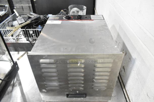 Weston 74-1001-W stainless steel food dehydrator, 120V, countertop model. Shows control panel and slotted vents. Some wear visible.
