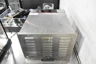 Weston 74-1001-W stainless steel food dehydrator, 120V, countertop model. Shows control panel and slotted vents. Some wear visible.