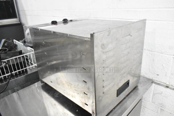 Weston 74-1001-W stainless steel countertop food dehydrator, 120V, used, with visible controls on top, slight wear.