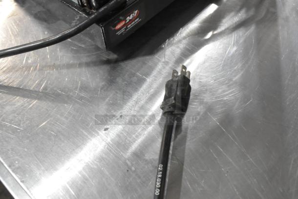 Hatco MDW-1X heated holding case power cord on metal countertop. Model: MDW-1X, 120V, 1 Phase. 