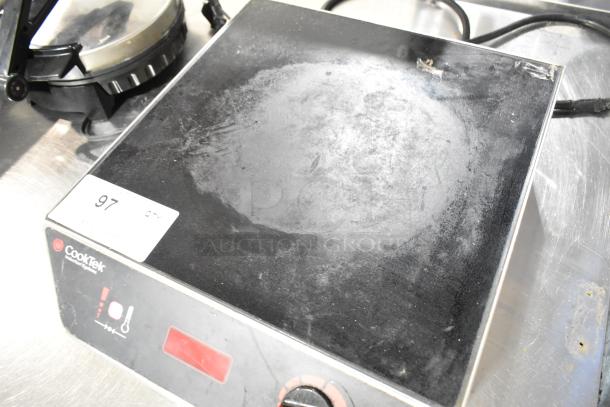 CookTek MC3000 stainless steel induction range, single burner, 208-240V, visible wear, CookTek label and controls shown.