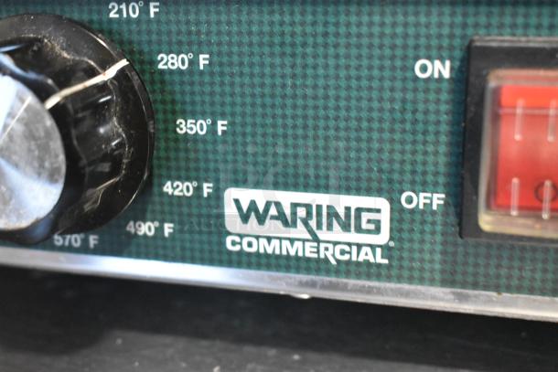 Waring WPG300 stainless steel commercial double panini press, 240V, 1 phase, temperature dial from 210°F to 570°F, "Waring Commercial" label.