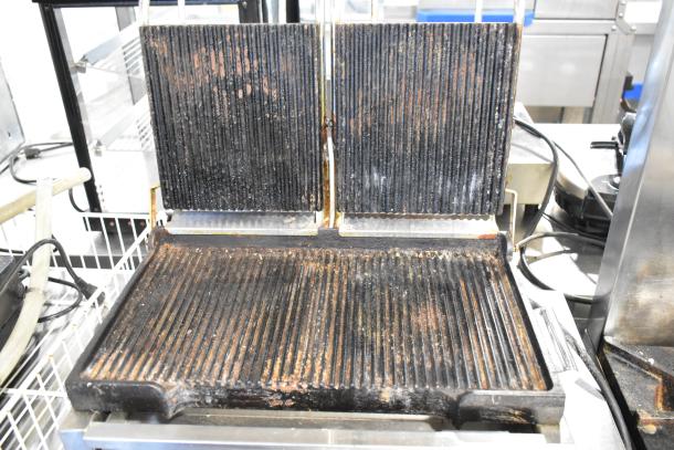 Waring WPG300 Stainless Steel Double Panini Press, commercial-grade, 240 volts, used condition with visible wear on cooking surfaces.