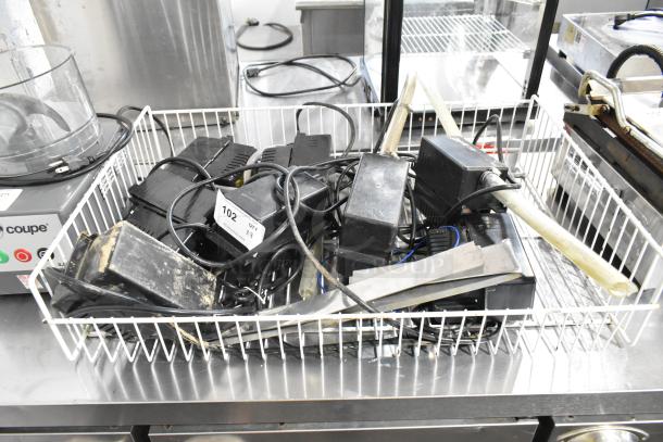 Basket containing eight Beckett CB121LSUK pumps, 120V, 1 phase, used condition. Visible auction tag indicates lot number 102.