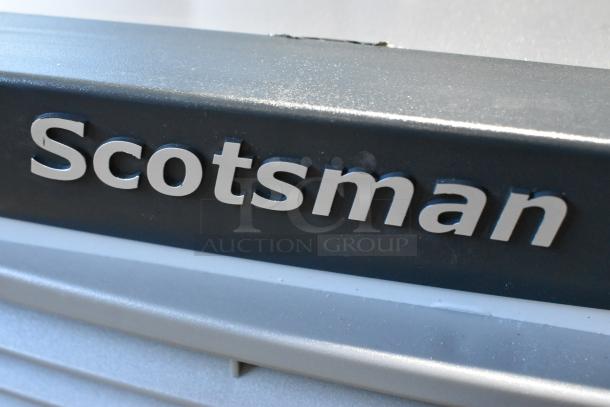 "Scotsman logo on stainless steel exterior of new Scotsman NS0922A-32B nugget ice machine, 956 lb capacity."