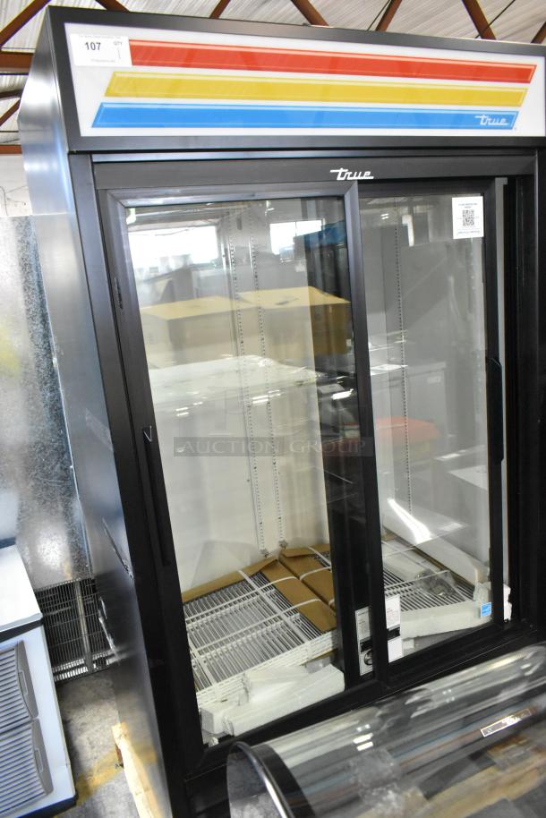 BRAND NEW True Metal 2 Door Reach-In Cooler Merchandiser with minor dents, poly-coated racks, and colorful header. 115V, 1 Phase.