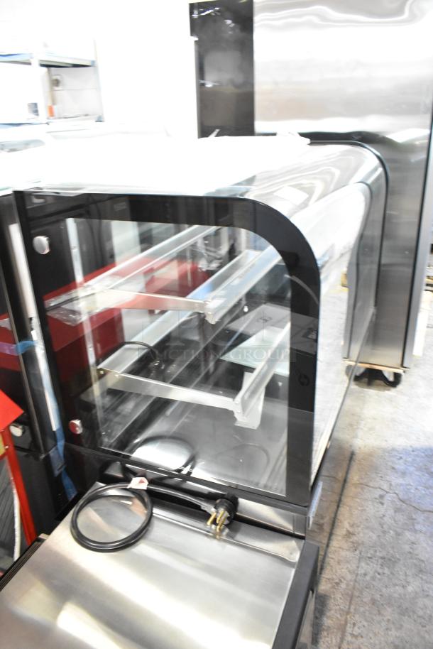 Brand new Avantco 193BCD48B 48" curved glass black dry bakery display case. Features shelves, minor cosmetic dents, 115V, 1 phase.