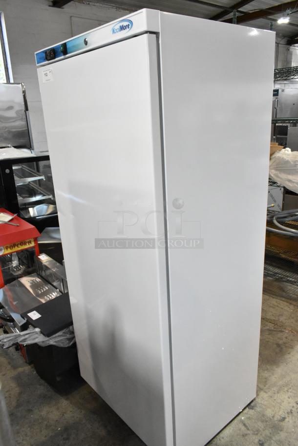 Brand new KoolMore KM-FMD20WH commercial freezer, single door, metal, poly-coated racks, 115V, 1 phase, minor dents visible.