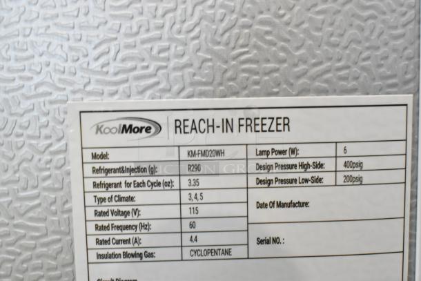 Brand new KoolMore KM-FMD20WH single door freezer, scratch and dent, 115V, poly coated racks, data tag shows model and specs.
