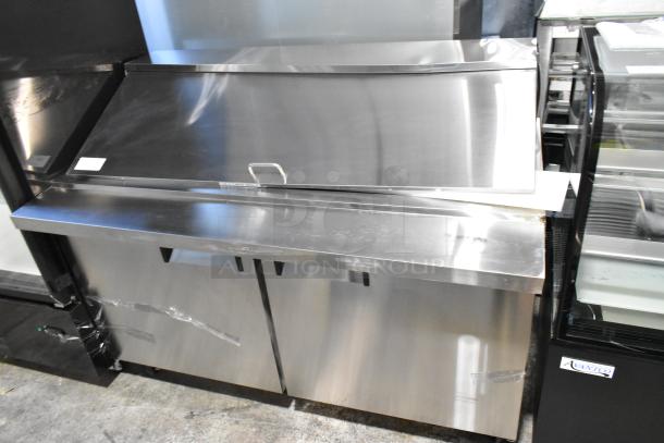 Brand new Avantco 178APT60MHC stainless steel 2-door refrigerated sandwich prep table with commercial casters and slight dents.