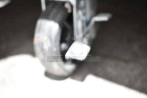 Blurry image of a caster wheel on the Avantco 178APT60MHC prep table, highlighting mobility feature.