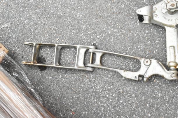 Belshaw metal commercial dough dropper with hopper and arm, used condition, visible branding and components on pavement.