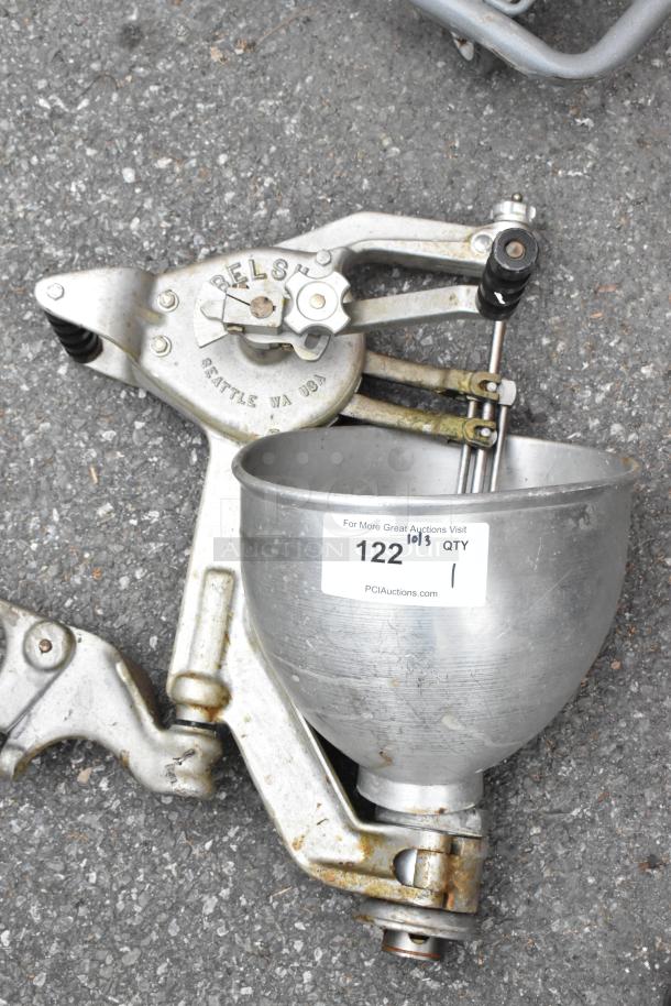 Belshaw metal commercial dough dropper with hopper and arm, showing signs of wear. Marked "Belshaw, Seattle WA USA." Auction tag number 122 visible.
