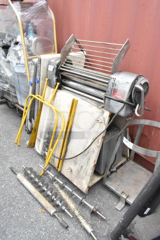Rondo Seewer metal commercial dough sheeter, disassembled, possibly missing pieces. Visible wear, includes rollers and frames.