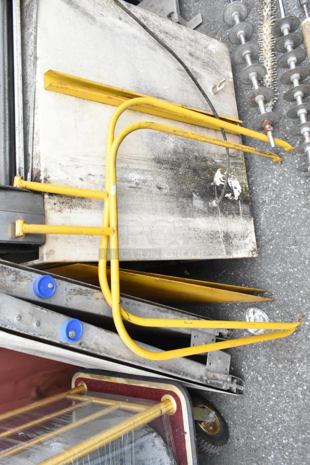 Rondo Seewer metal commercial dough sheeter components, unassembled, with yellow metal frames; possibly missing pieces.