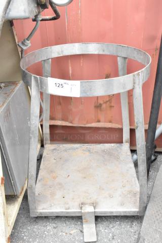 Metal mixing bowl stand with under shelf, shows wear, has label "125 QTY 1." Sturdy construction, ideal for kitchen use.