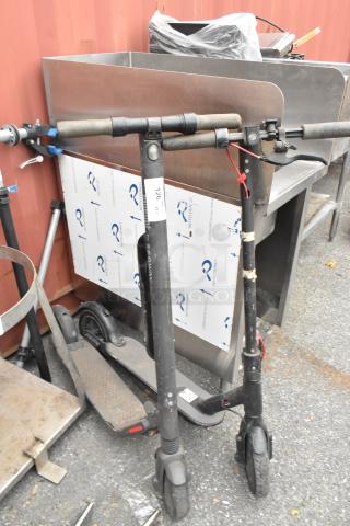 Two Segway scooters, used condition, black with visible wear. Includes auction tag "126."