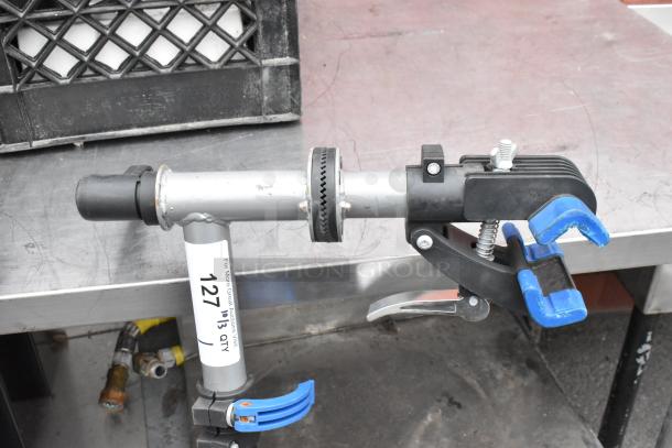 Metal clamp with adjustable stand, blue grips, and visible label reading "127 QTY." Sturdy and in good condition.