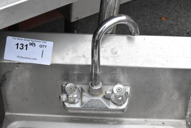 Stainless steel single bay sink with chrome faucet and hot/cold handles, good condition. Auction tag: "131, PCI Auctions."