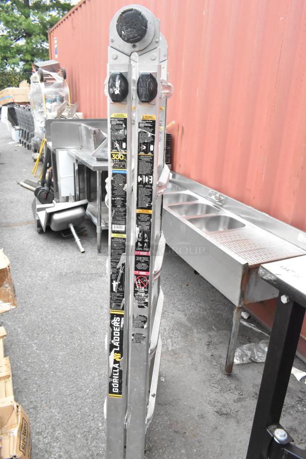 Gorilla Ladders metal convertible A-frame and flat ladder, 300 lb capacity, with safety labels visible, good condition.