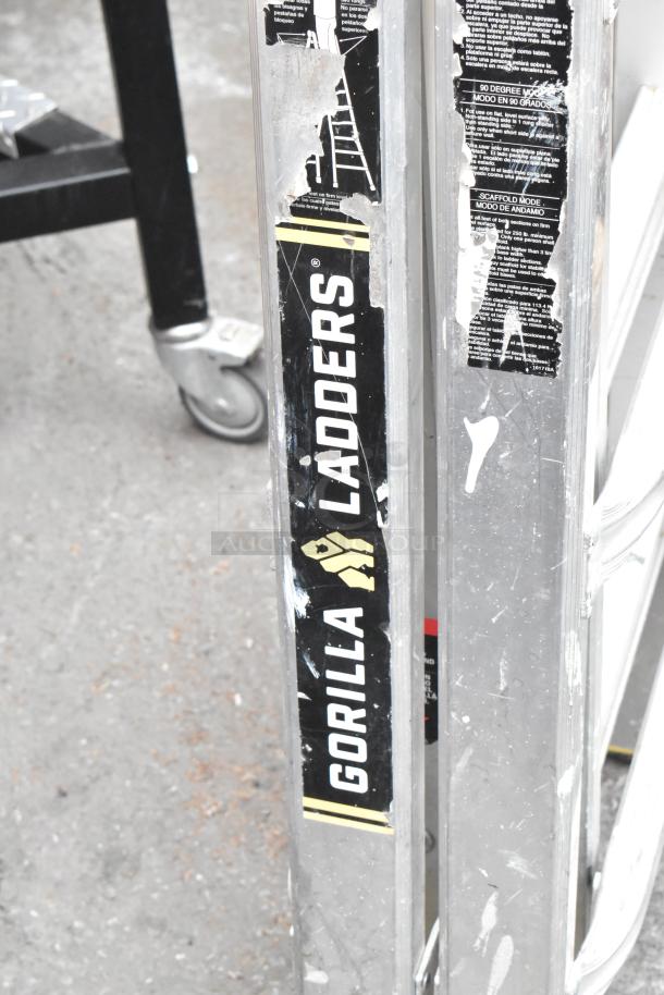 Gorilla Ladders metal convertible A-frame and flat ladder, 300 lb capacity, visible wear on labels, durable construction.