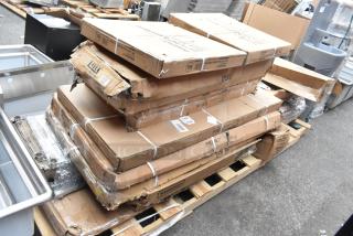 14 scratched and dented items, including Speed Rail and Wire Shelves, in original but damaged boxes on a pallet.