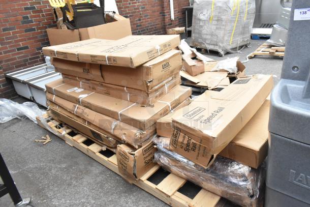 Boxes of brand-new scratch and dent items, including Steelon Speed Rail and wire shelves, stacked on a pallet.