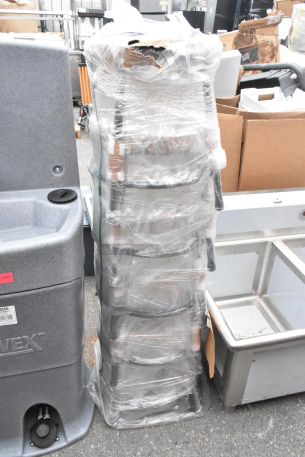 Stack of 5 new metal stools wrapped in plastic, labeled as "Scratch and Dent," indicating minor cosmetic flaws.
