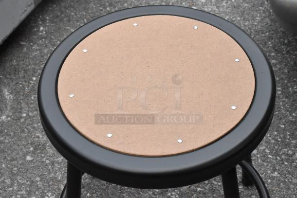 Five new metal stools, slightly scratched and dented, with wooden seats, ideal for home or bar use.