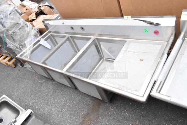 Brand new Regency 600S3182418R stainless steel 3-bay sink with right side drain board, no legs, scratch and dent condition.