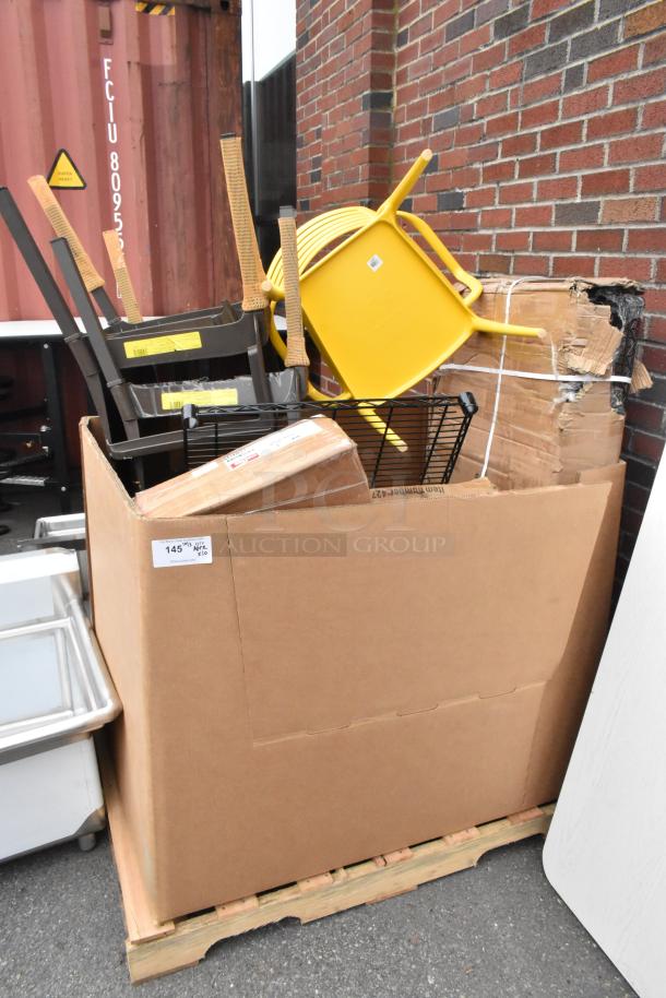 Box with wire shelves, chairs, and various items marked as scratch and dent. Includes yellow chair and wrapped packages.