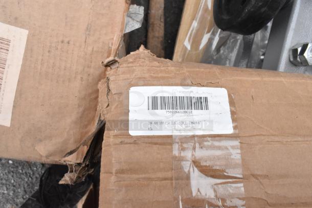 Damaged cardboard box with visible barcode label, marked "EQM-400/800 USA ELEC. SCALE, EQM400-NT NEW," suggesting a Tor Rey digital scale inside.