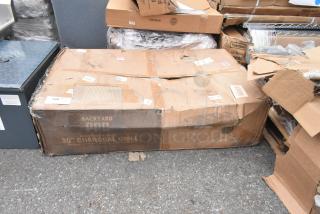 Brand new Backyard Pro CHAR-30 charcoal grill in damaged box. Features adjustable grates, removable legs, includes cover.
