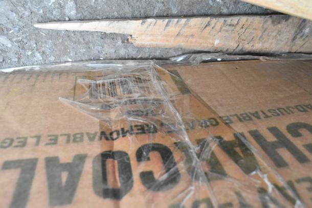 Cardboard packaging for a Backyard Pro CHAR-30 charcoal grill, visible text includes "CHAR," with clear tape and wear signs.