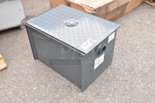 BRAND NEW Watts WD-15-THD 30 lb. grease trap with threaded connections, visible labels, minor cosmetic dent.