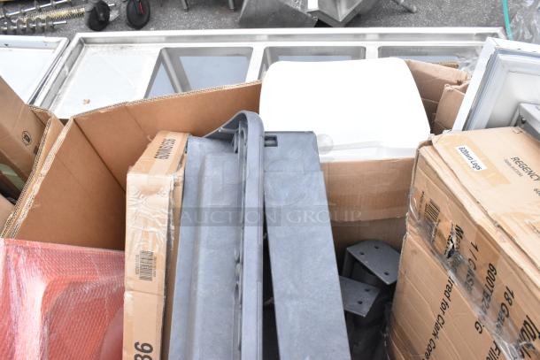 Auction items including new scratch and dent shelf, tabletop, and filler table in boxes. Labels show "82Omm Legs" and "Regency."