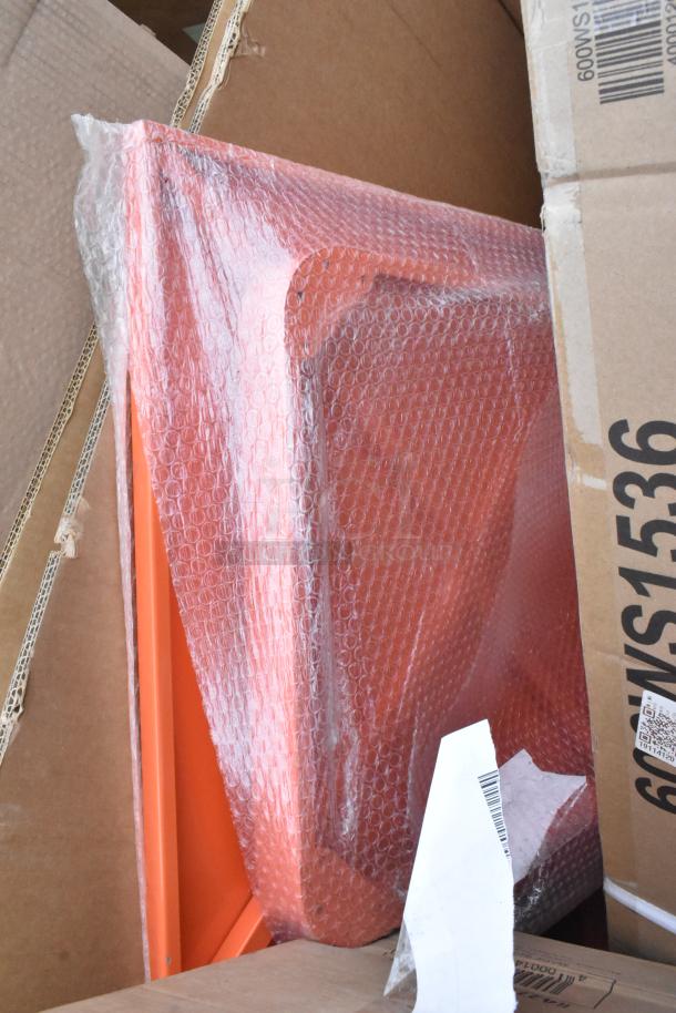 Brand new orange items wrapped in bubble wrap, including shelf and tabletop, seen among packing boxes.