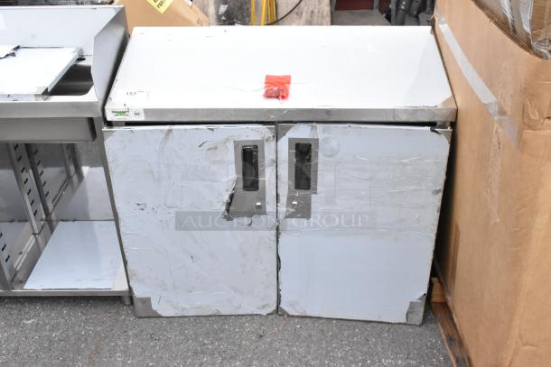 BRAND NEW SCRATCH AND DENT Regency 36" stainless steel wall cabinet with hinged doors, minor dents visible.
